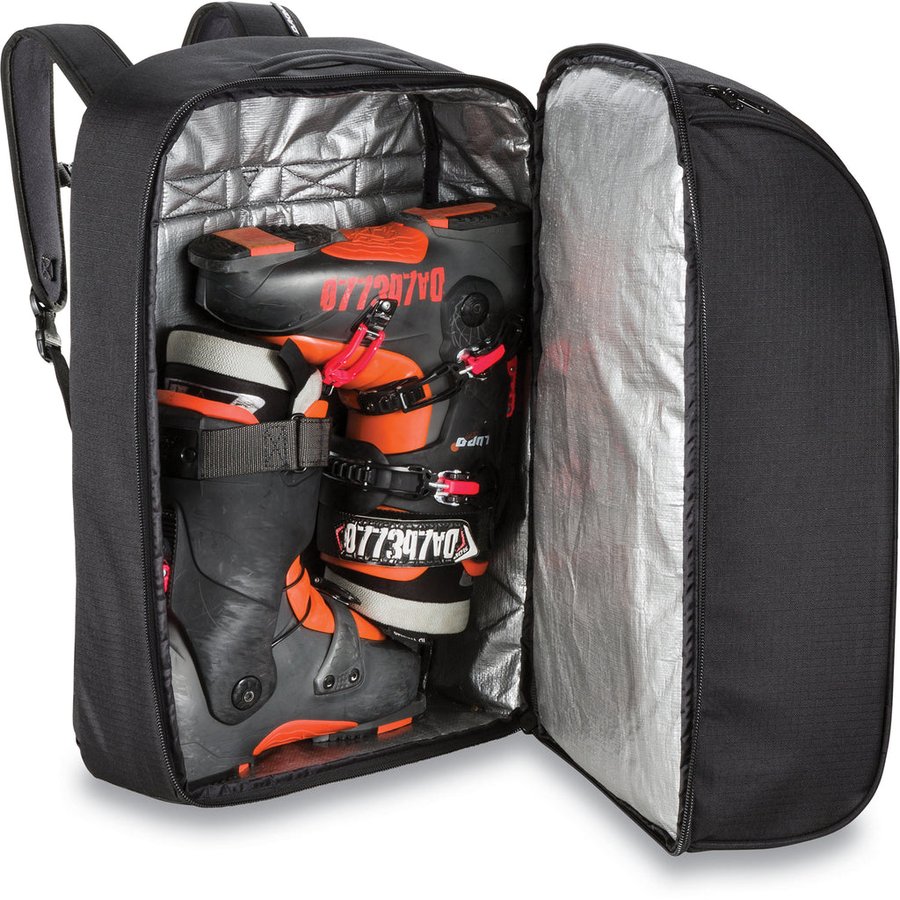 Dakine Boot Locker DLX 70L open, showing tarp-lined interior with ski boots inside